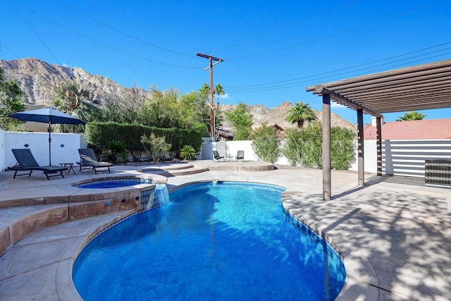 view of swimming pool with an in ground hot tub, a mountain view, and a patio