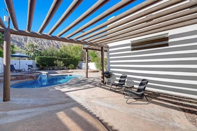 view of pool featuring a patio area and an in ground hot tub