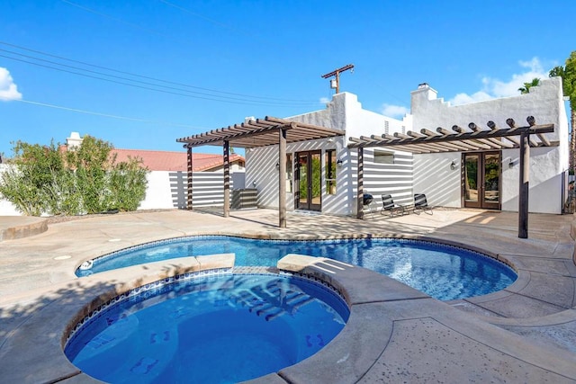 view of pool with french doors, a pergola, a patio, and an in ground hot tub