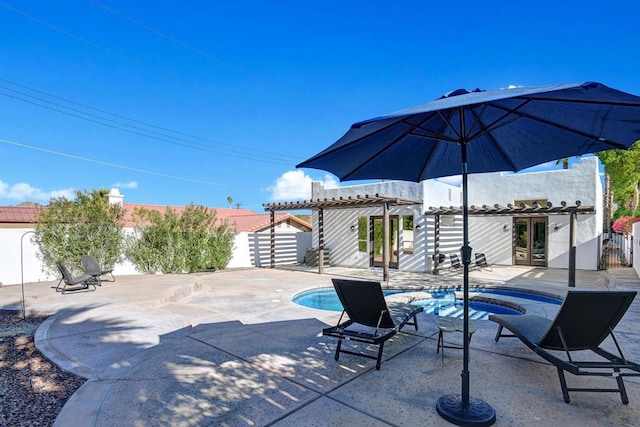 view of patio with a swimming pool with hot tub and a pergola