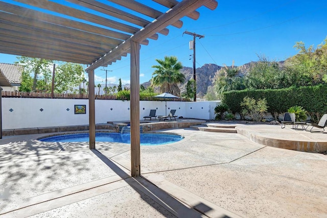 view of pool featuring a pergola, a patio area, a mountain view, and an in ground hot tub