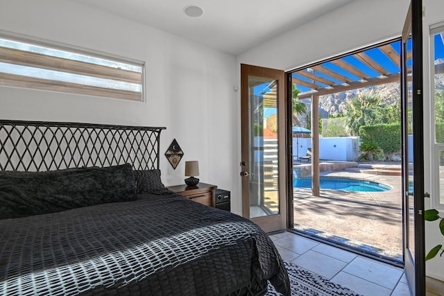 bedroom featuring access to outside and light tile patterned flooring