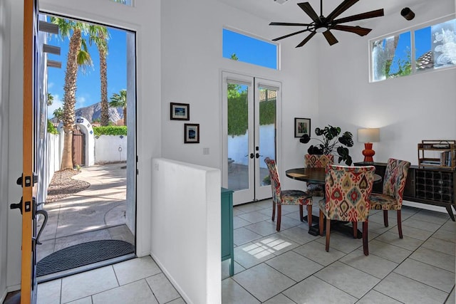 dining area with ceiling fan, french doors, and light tile patterned flooring