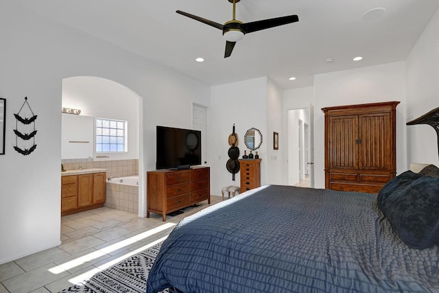 tiled bedroom with ceiling fan and connected bathroom