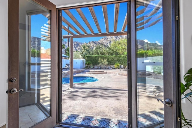 doorway with a healthy amount of sunlight and a water and mountain view