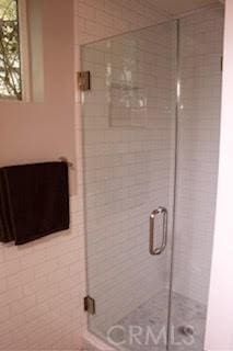 bathroom with a shower with door