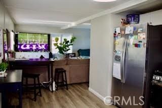 kitchen with stainless steel fridge with ice dispenser and hardwood / wood-style floors