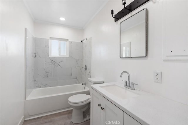 full bathroom with toilet, tiled shower / bath, wood-type flooring, ornamental molding, and vanity