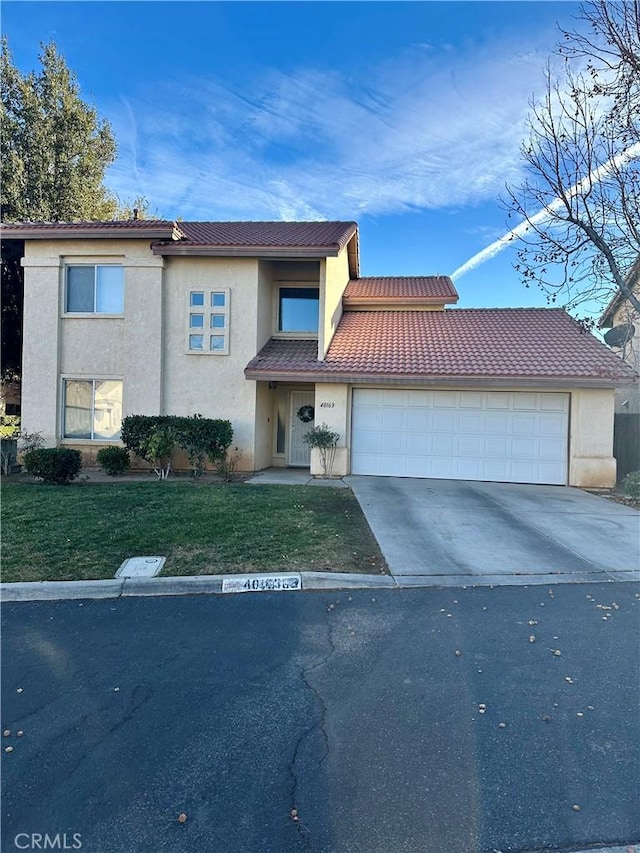 view of front of house with a garage and a front lawn