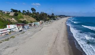 view of street featuring a beach view and a water view