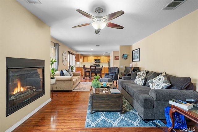 living room featuring ceiling fan and wood-type flooring