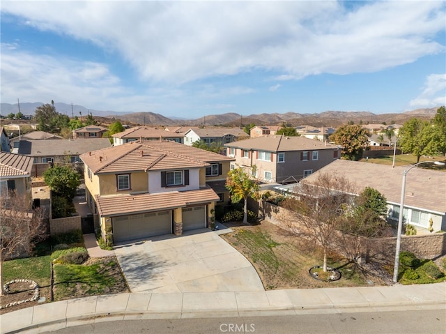 view of front of property with a garage and a mountain view