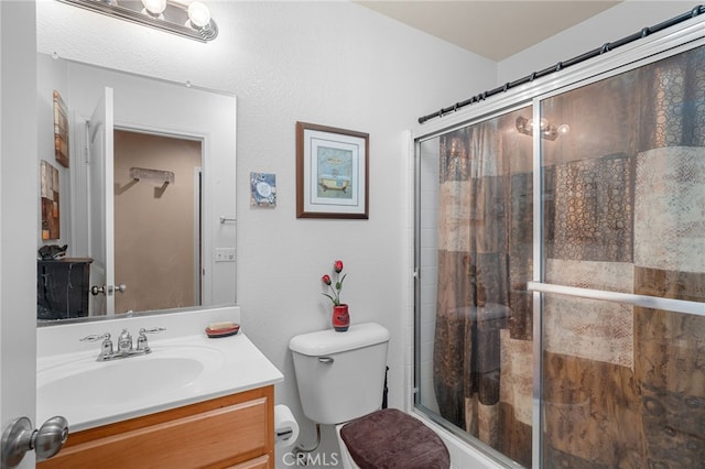 bathroom with an enclosed shower, vanity, and toilet