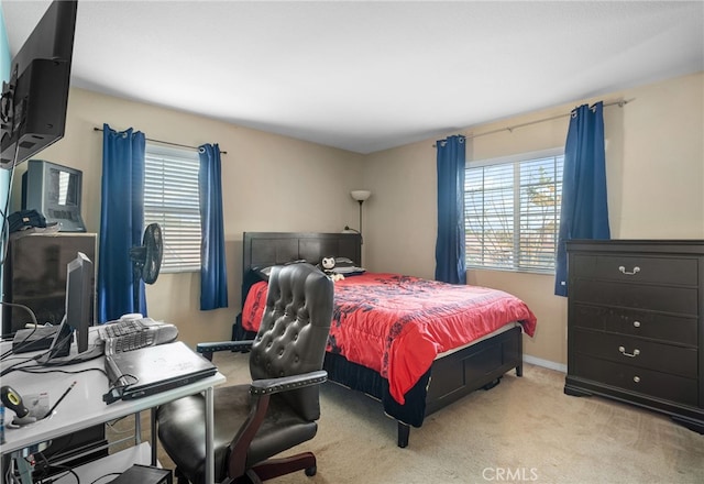 bedroom featuring light colored carpet and multiple windows