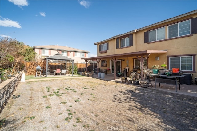 rear view of property with a patio area and a gazebo