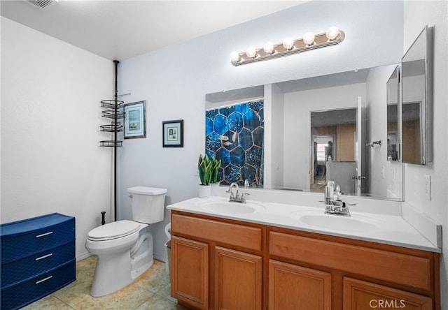 bathroom with toilet, tile patterned flooring, and vanity