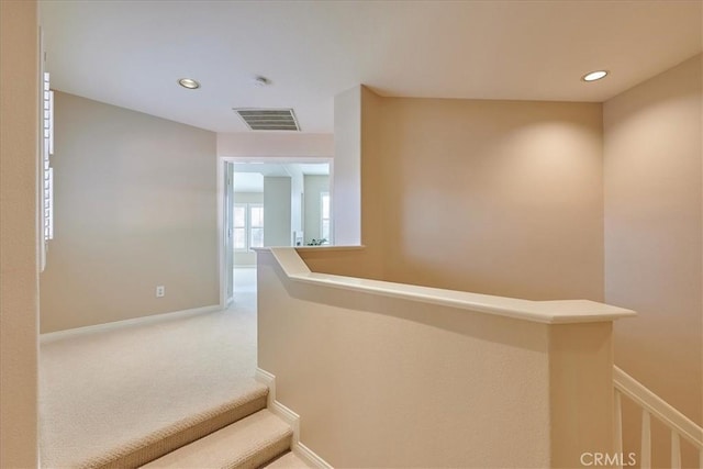 hallway featuring carpet flooring