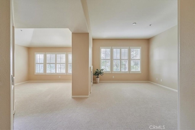 unfurnished living room with light colored carpet