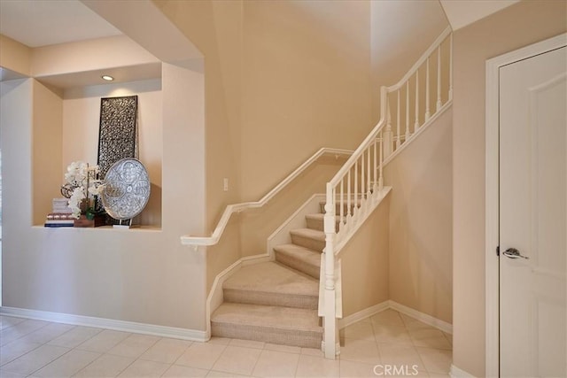 staircase featuring tile patterned floors