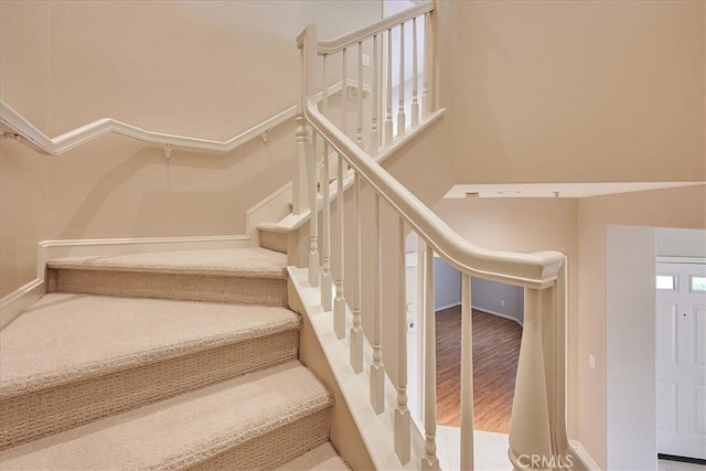 staircase with hardwood / wood-style flooring