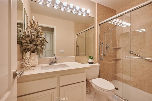 bathroom with a shower with shower door, toilet, and vanity