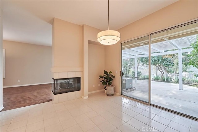 unfurnished living room featuring a fireplace and tile patterned floors