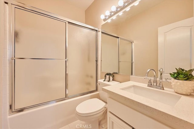 full bathroom featuring toilet, vanity, and shower / bath combination with glass door