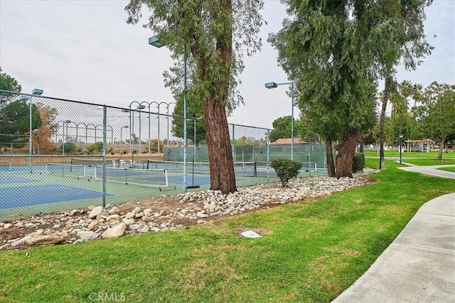 view of sport court featuring a yard