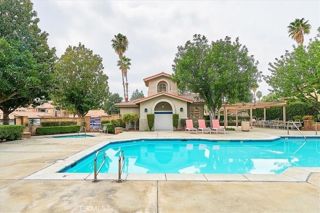 view of swimming pool with a patio and a pergola