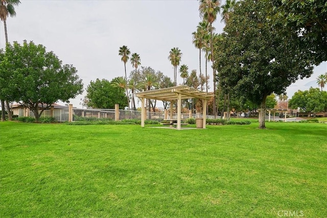 view of yard featuring fence and a pergola