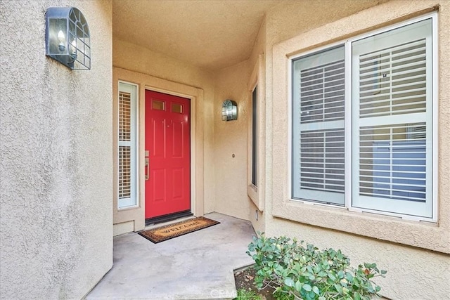 doorway to property with stucco siding