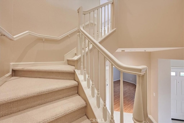 stairs featuring baseboards and wood finished floors