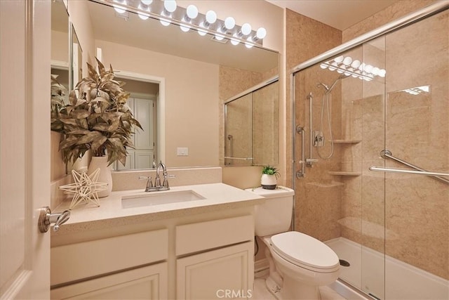 full bath featuring a tile shower, vanity, and toilet