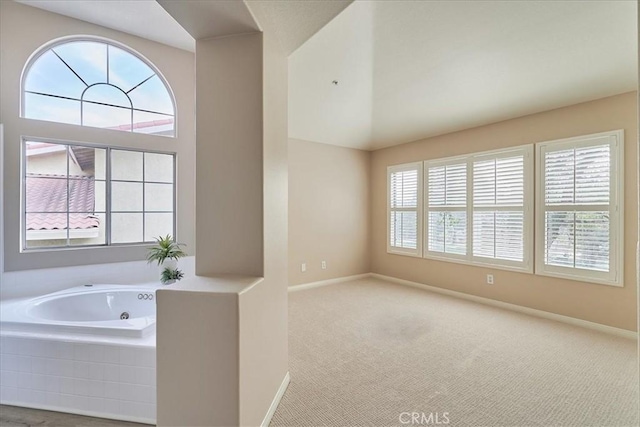 bathroom with a whirlpool tub and baseboards