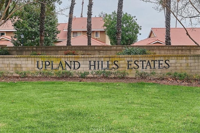 community / neighborhood sign with a lawn