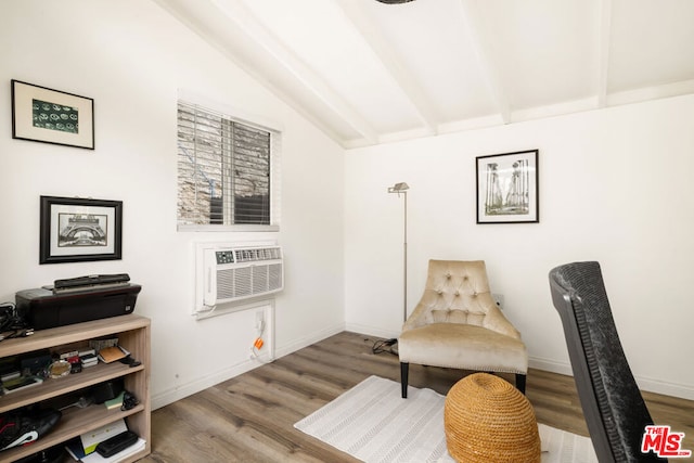 living area featuring vaulted ceiling with beams, a wall mounted AC, and hardwood / wood-style floors