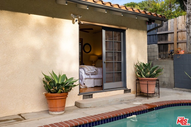 property entrance featuring a fenced in pool