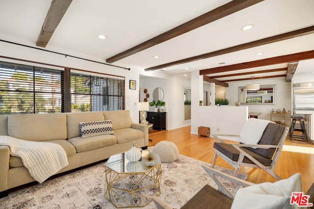 living room featuring beam ceiling and light wood-type flooring