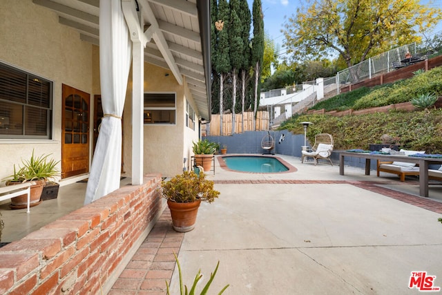 view of swimming pool featuring a patio area