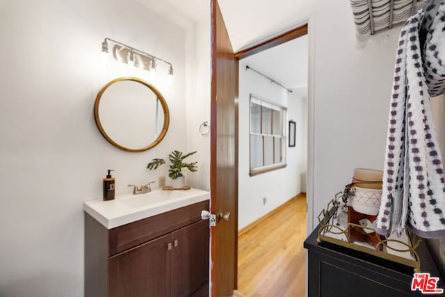 bathroom with hardwood / wood-style flooring and vanity