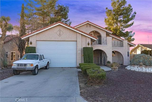 view of front of home with a garage and a balcony