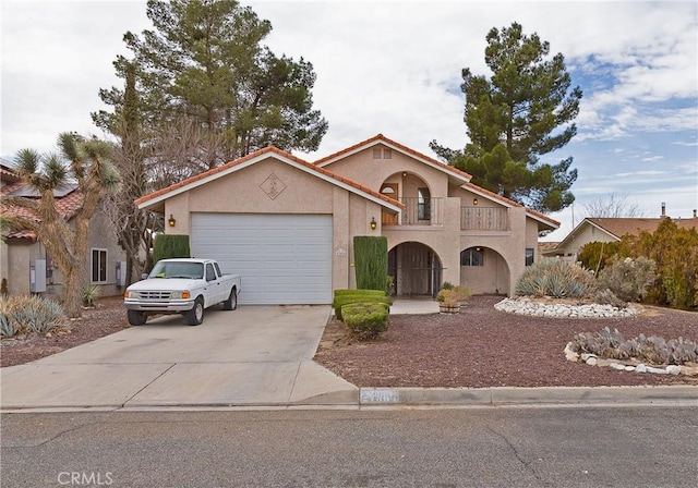 view of front of home with concrete driveway, an attached garage, a balcony, and stucco siding