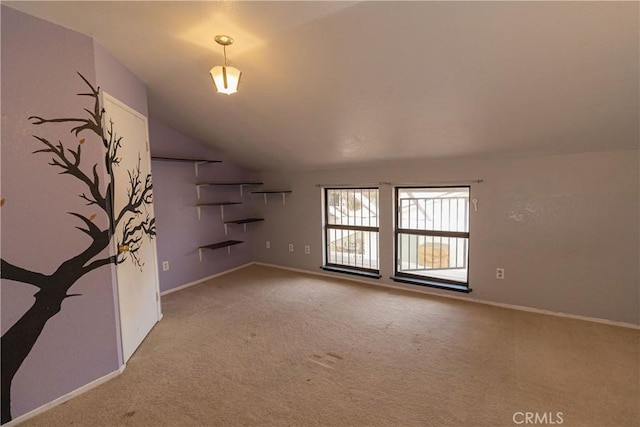 unfurnished living room featuring vaulted ceiling and light carpet