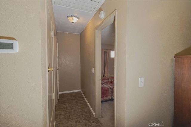 hallway featuring baseboards