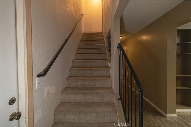 stairway featuring wood-type flooring