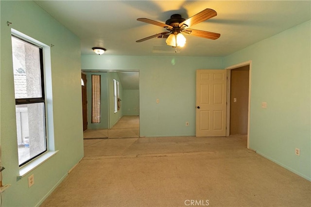 carpeted empty room featuring ceiling fan