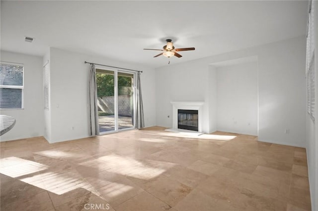 unfurnished living room with ceiling fan