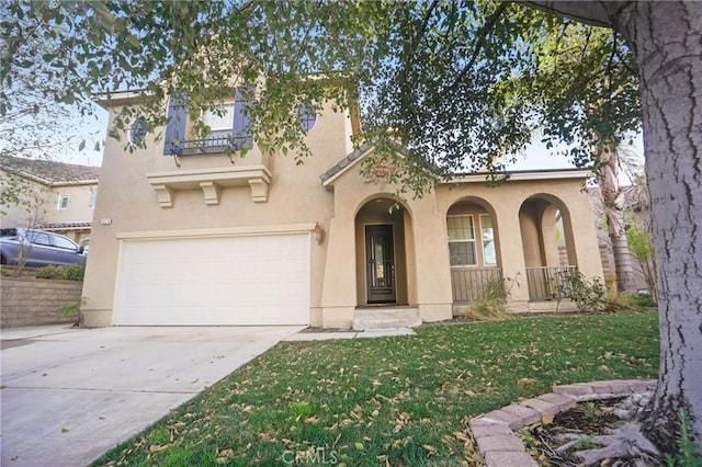 mediterranean / spanish house featuring a garage and a front lawn