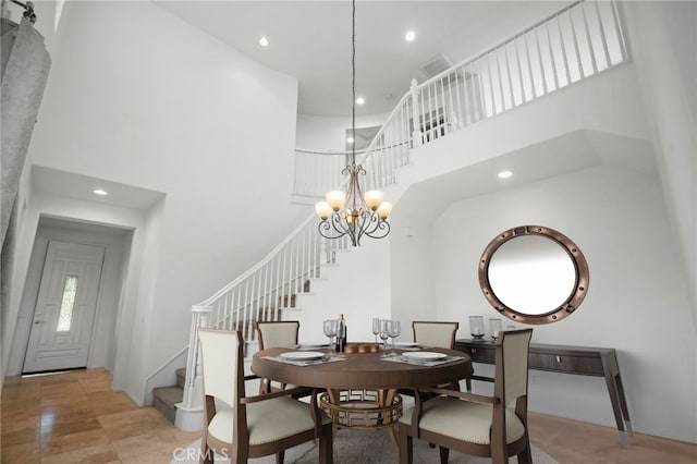 dining area with a notable chandelier and a high ceiling