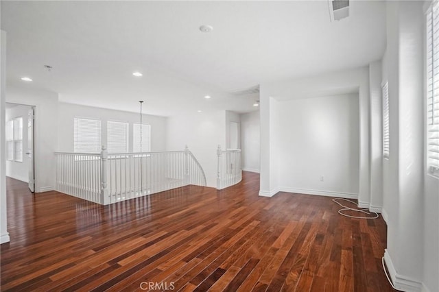 spare room featuring dark hardwood / wood-style flooring